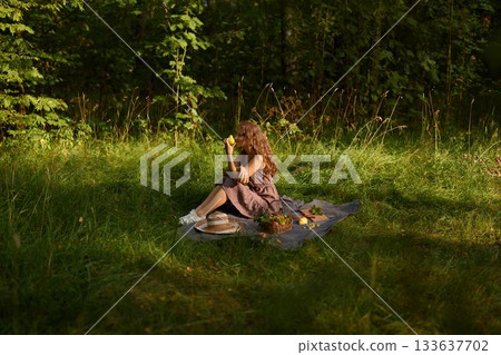 Woman relaxes amid nature, Calm female reader rests in sunny field 133637702