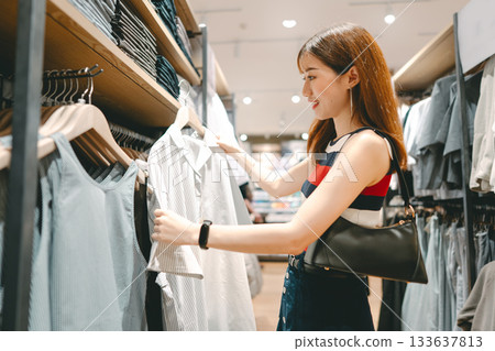 Happy asian woman shopping clothes in fashion shoping mall 133637813