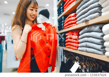 Happy asian woman shopping clothes in fashion shoping mall on black friday sale 133637826