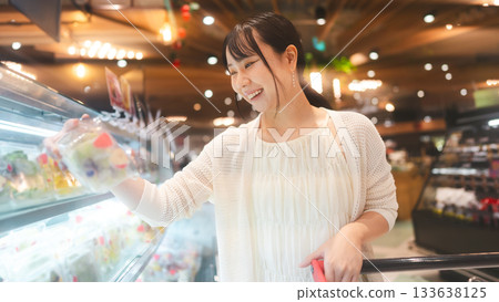 Young asian woman supermarket shopping cart choosing fruit products grocery food at department store Young asian woman supermarket shopping cart choosing fruit products grocery food at department store 133638125