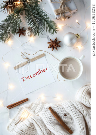 Cozy December flat lay with winter decorations and candlelight glow Cozy December flat lay with winter decorations and candlelight glow 133638258