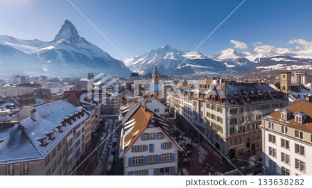 Mountain view over a snowy village in Switzerland during a clear winter day 133638282