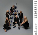 Group of stylish individuals posing creatively in contemporary studio setting 133638451