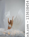 Beautiful woman with angel wings in a dreamy studio setting 133638454
