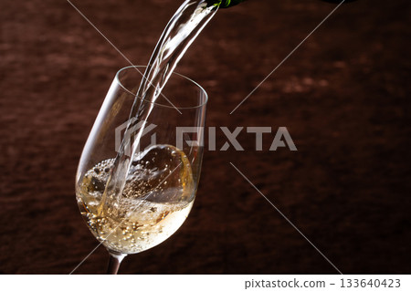 Pour white wine 133640423