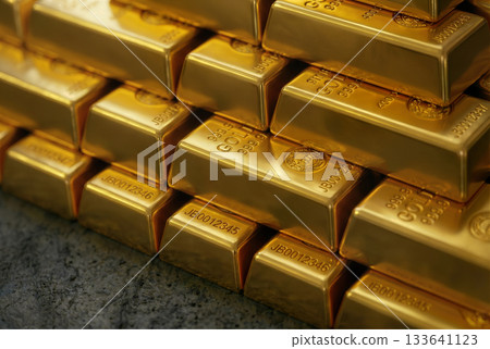 A row of gold bars lined up neatly and continuing deep into the building - an image of asset value and stable investment 133641123