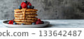 A stack of fluffy pancakes made with oat flour topped with fresh berries and almond butter 133642487