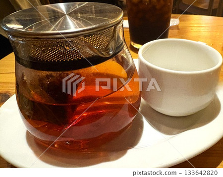 Black tea poured into a tea cup Black tea poured into a tea cup 133642820