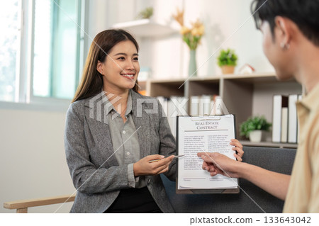 Real Estate Agent Presenting Contract to Client 133643042