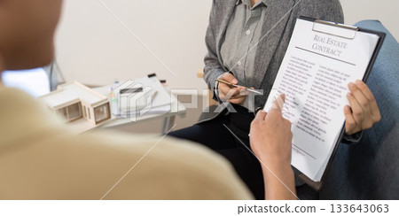 Real Estate Agent Discussing Contract with Client 133643063