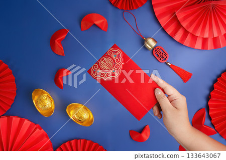 Lunar New Year red envelope and gold ingots on blue background 133643067