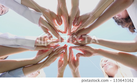 An inspiring display of unity with a variety of diverse hands reaching together in a beautiful circular formation An inspiring display of unity with a variety of diverse hands reaching together in a beautiful circular formation 133643162