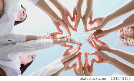 A beautifully creative arrangement of various hands forming heart shapes, symbolizing unity and teamwork A beautifully creative arrangement of various hands forming heart shapes, symbolizing unity and teamwork 133643163