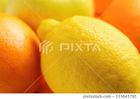 A pile of fresh citrus fruits. Lemons and oranges. A pile of fresh citrus fruits. Lemons and oranges. 133643795