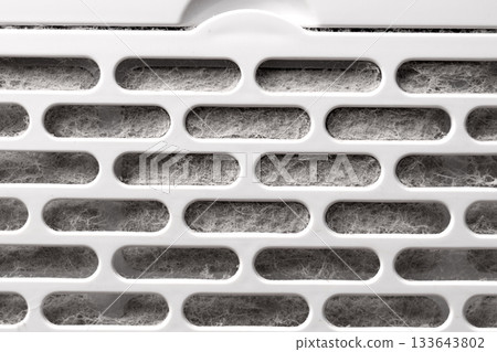 Dirty dusty filter grill of a home air purifier close up. Maintenance service concept Dirty dusty filter grill of a home air purifier close up. Maintenance service concept 133643802
