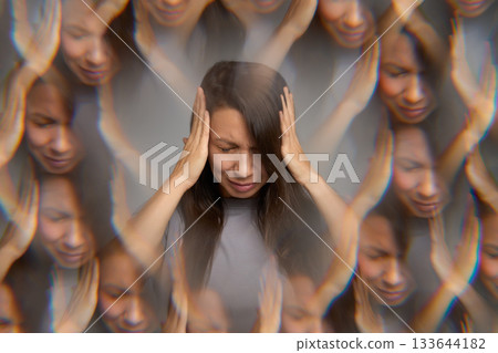 Stressed woman suffering from headache holding her head with hands Stressed woman suffering from headache holding her head with hands 133644182