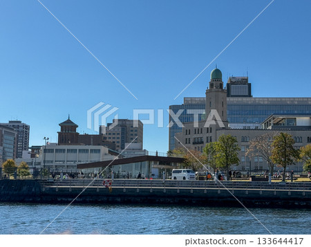 A yellow water bus runs along the waterway between the buildings of Minato Mirai. November 2025, Yokohama, Japan 133644417
