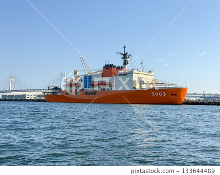 The Antarctic research vessel Shirase and the Bay Bridge floating on a clear blue sea, November 2025, Yokohama, Japan 133644489