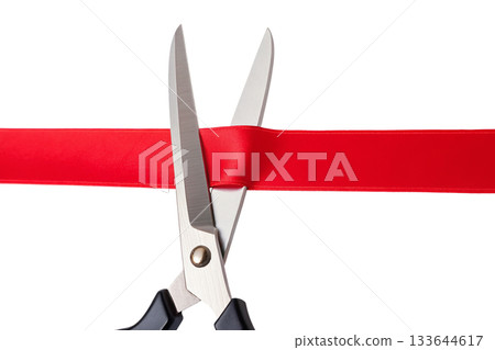 Ceremonial moment of scissors cutting a bold red ribbon for a grand opening, symbolizing new beginnings for a business, event 133644617