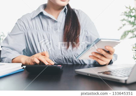 Business woman analyze calculate company financial, tax results office accounting statistics analytical research. calculating business balance prepare tax reduction. Tax deduction planning concept. 133645351