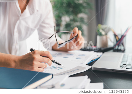 Business woman analyze calculate company financial, tax results office accounting statistics analytical research. calculating business balance prepare tax reduction. Tax deduction planning concept. 133645355