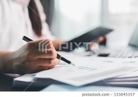 Business woman analyze calculate company financial, tax results office accounting statistics analytical research. calculating business balance prepare tax reduction. Tax deduction planning concept. Business woman analyze calculate company financial, tax results office accounting statistics analytical research. calculating business balance prepare tax reduction. Tax deduction planning concept. 133645357