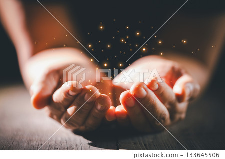 Hands clasped in prayer over the holy Bible, the faithful Christian worships God in church, holding onto hope and belief, guided by religion and a deep commitment to their religious faith. 133645506
