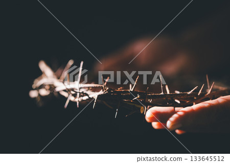 Closeup of Jesus Christ wearing crown of thorns during His crucifixion captures the suffering, sacrifice, and deep spirituality that define Easter and the core of Christian faith and religion. 133645512