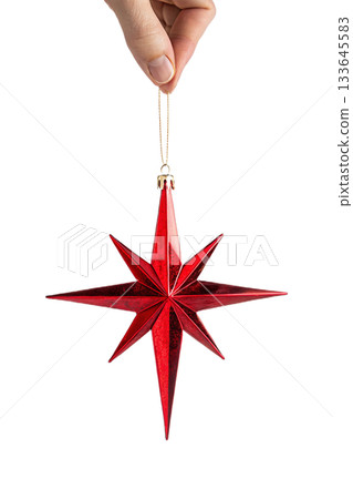 Hand holding shiny, reflective red christmas star ornament against transparent background, symbolizing holiday decoration and festive spirit Hand holding shiny, reflective red christmas star ornament against transparent background, symbolizing holiday decoration and festive spirit 133645583