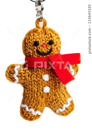 Charming handmade knitted gingerbread man keychain wearing a red scarf, a cute christmas amigurumi toy isolated on transparent background 133645585