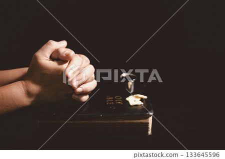 Hands holding communion bread with a wooden bowl and wine cup, symbolizing Holy Communion, the Eucharist, the sacrifice of Jesus Christ and Christian faith in the Lord Supper. Hands holding communion bread with a wooden bowl and wine cup, symbolizing Holy Communion, the Eucharist, the sacrifice of Jesus Christ and Christian faith in the Lord Supper. 133645596