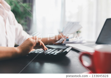 Business woman analyze calculate company financial, tax results office accounting statistics analytical research. calculating business balance prepare tax reduction. Tax deduction planning concept. Business woman analyze calculate company financial, tax results office accounting statistics analytical research. calculating business balance prepare tax reduction. Tax deduction planning concept. 133645828