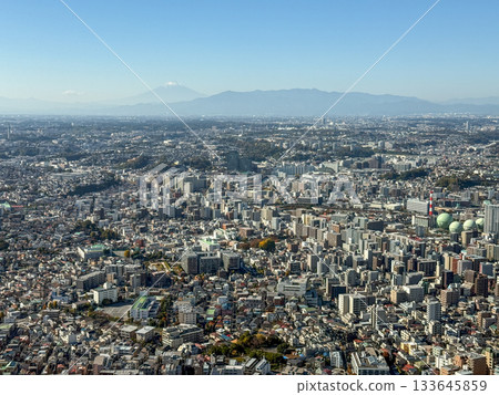 Dense urban areas and the majestic Mount Fuji in the distance. November 2025, Yokohama, Japan Dense urban areas and the majestic Mount Fuji in the distance. November 2025, Yokohama, Japan 133645859