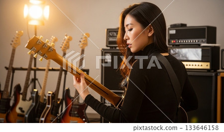 A woman playing the guitar 133646158