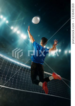 Vibrant artwork of male volleyball player jumping for powerful spike above net under arena lights. Vibrant artwork of male volleyball player jumping for powerful spike above net under arena lights. 133646169