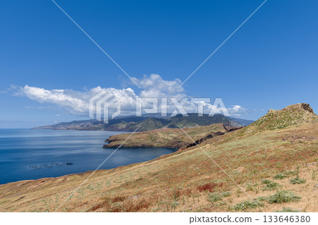 Madeira Ponta de Sao Lourenco coastline with dry slope above calm blue bay distant mountains Madeira Ponta de Sao Lourenco coastline with dry slope above calm blue bay distant mountains 133646380