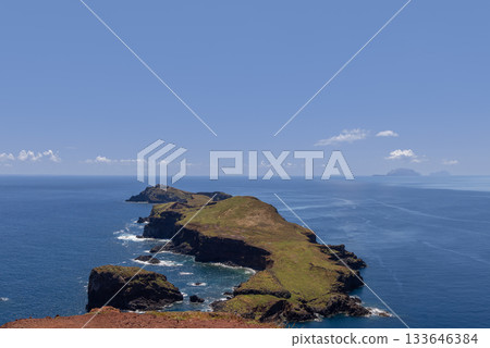 Madeira Sao Lourenco coast with distant islands and lighthouse along layered rocky shore Madeira Sao Lourenco coast with distant islands and lighthouse along layered rocky shore 133646384