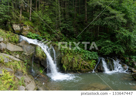 Mountain waterfall in the forest. Green nature. 133647447