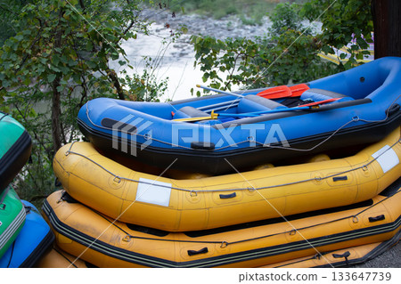 Rubber boats are colorful for rafting. Active recreation during the trip Rubber boats are colorful for rafting. Active recreation during the trip 133647739