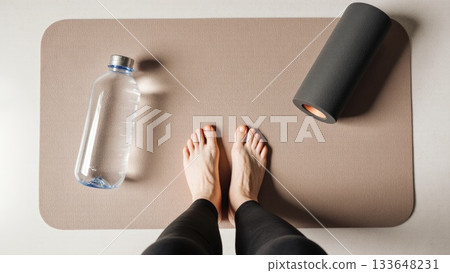 Post Workout Recovery Flat Lay with Bare Feet on Mat Post Workout Recovery Flat Lay with Bare Feet on Mat 133648231