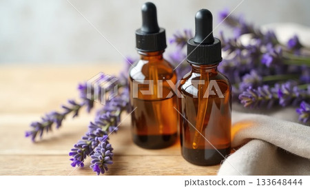 Amber Serum Bottles with Lavender on Oak Wood Amber Serum Bottles with Lavender on Oak Wood 133648444