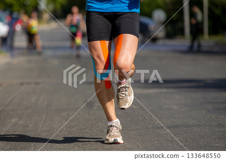 Runner feet in kinesiotape 133648550