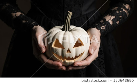 Elegant Hands in Black Lace Holding White Victorian Jack-o-Lantern 133648690