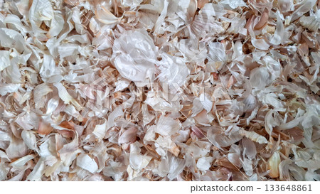 Textured Background of Dry Garlic Peels. Close-up View of Scattered Allium Sativum Husks Textured Background of Dry Garlic Peels. Close-up View of Scattered Allium Sativum Husks 133648861