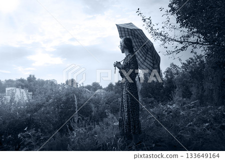Young girl with big umbrella Young girl with big umbrella 133649164