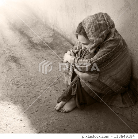 Frozen girl sitting on the floor 133649194