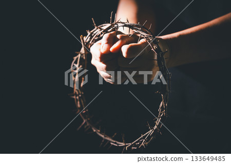 Closeup of Jesus Christ wearing crown of thorns during His crucifixion captures the suffering, sacrifice, and deep spirituality that define Easter and the core of Christian faith and religion. Closeup of Jesus Christ wearing crown of thorns during His crucifixion captures the suffering, sacrifice, and deep spirituality that define Easter and the core of Christian faith and religion. 133649485
