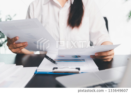 Business woman analyze calculate company financial, tax results office accounting statistics analytical research. calculating business balance prepare tax reduction. Tax deduction planning concept. Business woman analyze calculate company financial, tax results office accounting statistics analytical research. calculating business balance prepare tax reduction. Tax deduction planning concept. 133649607