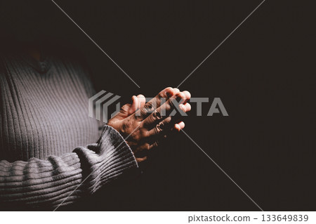 Person holding hands together in prayer gesture, symbolizing hope, faith, meditation, spirituality, trust, belief, peace, devotion, inner strength and resilience during hard times. Person holding hands together in prayer gesture, symbolizing hope, faith, meditation, spirituality, trust, belief, peace, devotion, inner strength and resilience during hard times. 133649839
