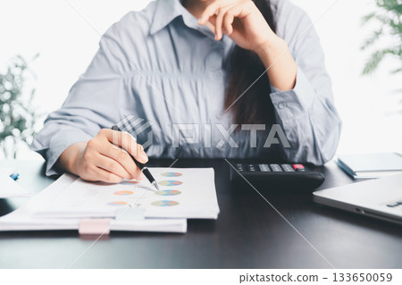 Business woman analyze calculate company financial, tax results office accounting statistics analytical research. calculating business balance prepare tax reduction. Tax deduction planning concept. Business woman analyze calculate company financial, tax results office accounting statistics analytical research. calculating business balance prepare tax reduction. Tax deduction planning concept. 133650059